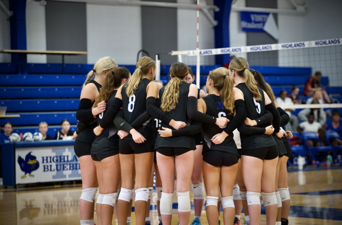 The HHS Varsity volleyball team huddles up before their game against Holmes begins. When asked about what she’s most looking forward to, Lyla Bottom (12) said, “I’m looking forward to a good season. This team has good chemistry."